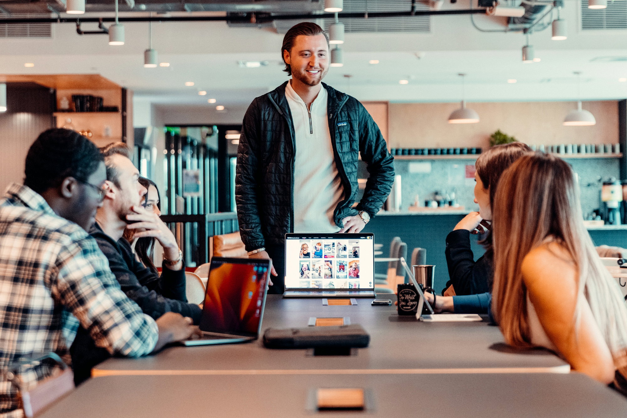 A group of colleagues sitting around a table in a bright meeting room